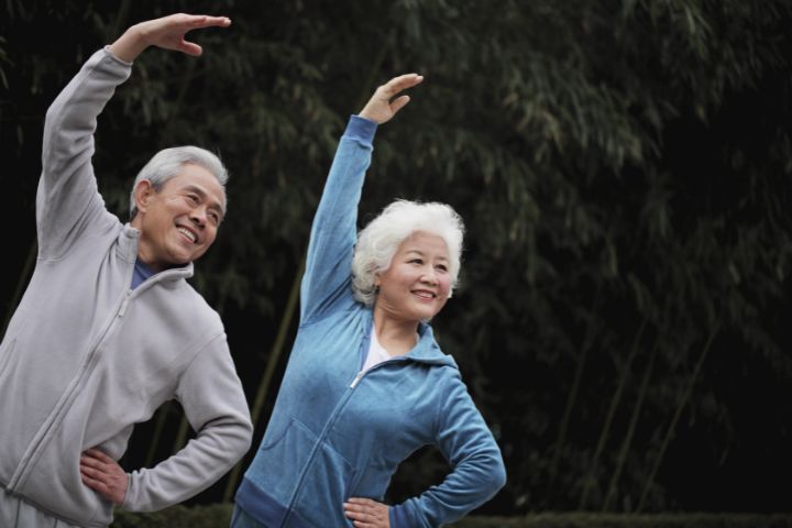 elderly couple stretching outdoor after dialysis